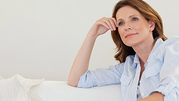 Woman enjoying a calm moment with coffee, feeling balanced through menopause