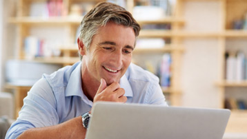 Man reviewing testosterone replacement therapy program details and treatment options